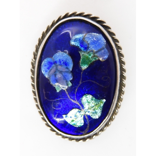 827 - A ENAMELLED ARTS & CRAFTS BROOCH BY ALICE WAYMOUTHthe fine enamelled panel of violet flowers is ... 