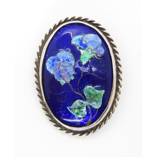 827 - A ENAMELLED ARTS & CRAFTS BROOCH BY ALICE WAYMOUTHthe fine enamelled panel of violet flowers is ... 