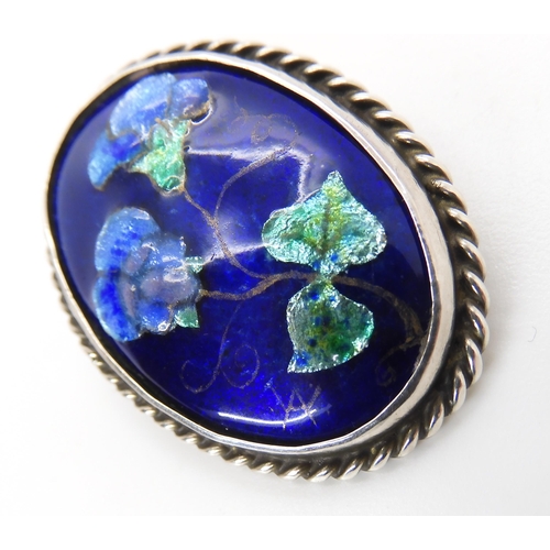 827 - A ENAMELLED ARTS & CRAFTS BROOCH BY ALICE WAYMOUTHthe fine enamelled panel of violet flowers is ... 