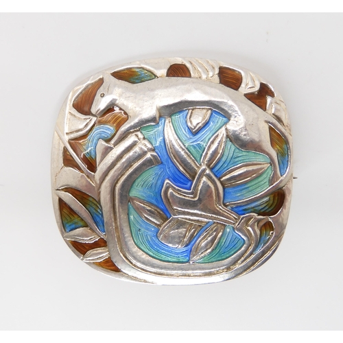 830 - A NORWEGIAN ENAMELLED BROOCH BY JACOB TOSTRUPa stylised cat amongst foliage, enamelled in blue green... 