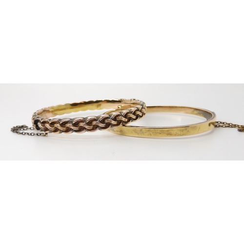 834 - TWO BRIGHT YELLOW METAL VINTAGE BANGLESa knot pattern bangle, with all over pattern and box clasp. I... 