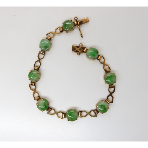 835 - A 9CT GOLD CHINESE GREEN HARDSTONE BRACELETthe hardstones measure 8.3mm approx each with decorative ... 