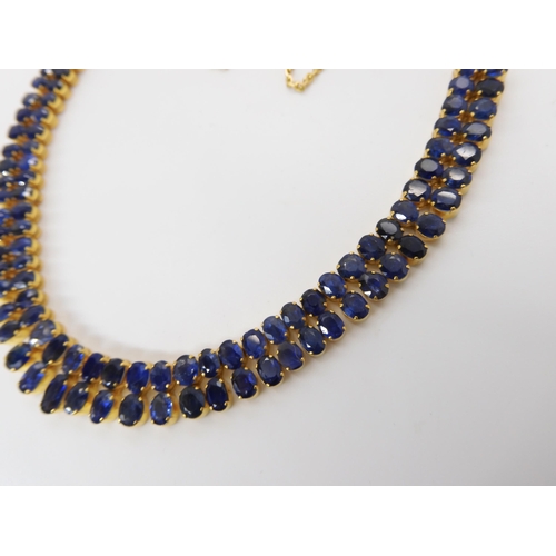849 - AN 18CT GOLD GRADUATED SAPPHIRE NECKLACEset with ninety-six facet cut sapphires which range in size ... 