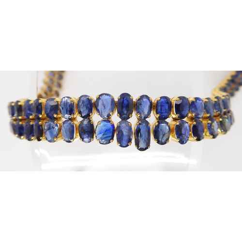 849 - AN 18CT GOLD GRADUATED SAPPHIRE NECKLACEset with ninety-six facet cut sapphires which range in size ... 