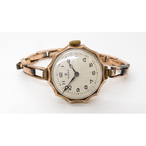 870 - A 9CT GOLD LADIES VINTAGE ROLEXcirca 1922, with pie crust bezel , a white scalloped fan pattern dial... 