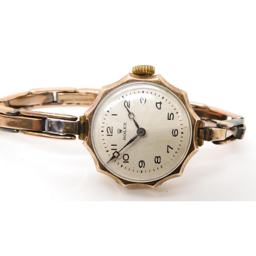 870 - A 9CT GOLD LADIES VINTAGE ROLEXcirca 1922, with pie crust bezel , a white scalloped fan pattern dial... 