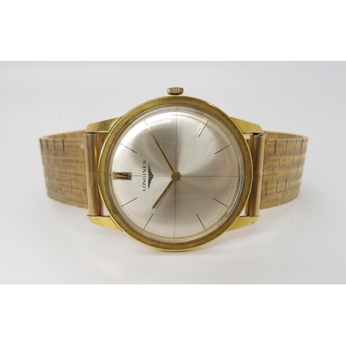 875 - AN 18CT GOLD LONGINES WATCH HEADwith cream dial, gold coloured baton numeral and hands, with a 9ct g... 