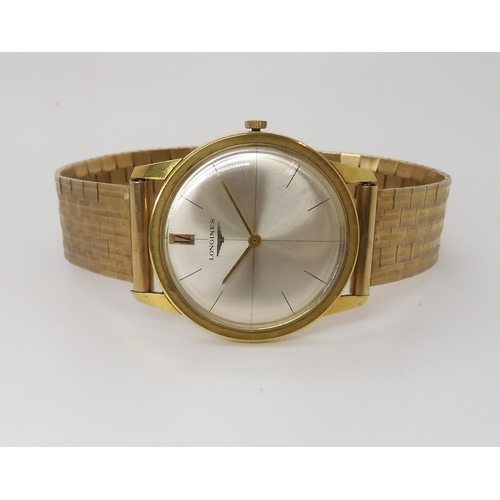 875 - AN 18CT GOLD LONGINES WATCH HEADwith cream dial, gold coloured baton numeral and hands, with a 9ct g... 