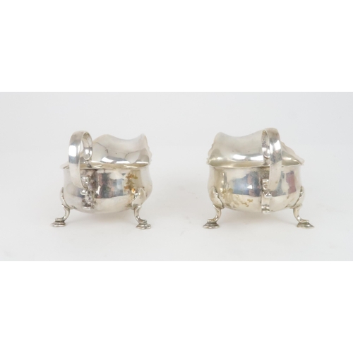 905 - A CASED PAIR OF SILVER SAUCEBOATS by Martin Hall & Co. Sheffield 1919, of classic form with scro... 