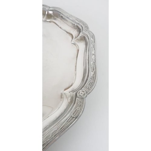 906 - A SILVER SALVER by Sharman D Neill, Chester 1928 of circular form, the scalloped rim with Celtic dec... 