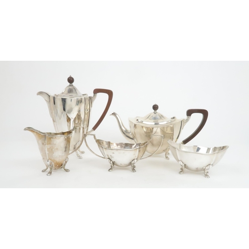 911 - A FIVE PIECE SILVER TEA SERVICE by Barker Brothers Silver Ltd, Birmingham 1936, comprising teapot, h... 