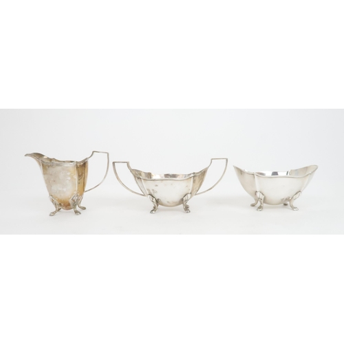 911 - A FIVE PIECE SILVER TEA SERVICE by Barker Brothers Silver Ltd, Birmingham 1936, comprising teapot, h... 