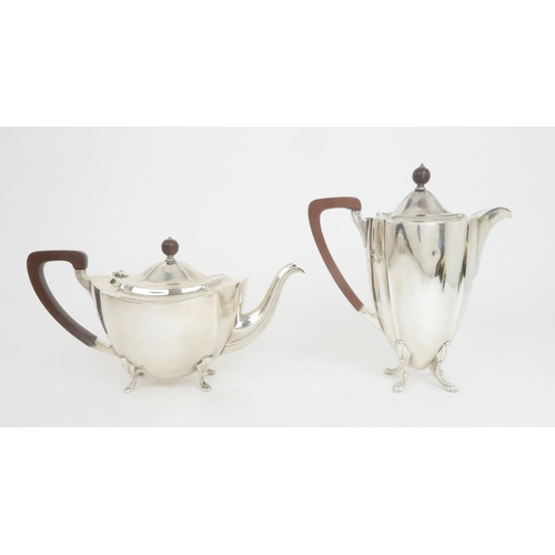 911 - A FIVE PIECE SILVER TEA SERVICE by Barker Brothers Silver Ltd, Birmingham 1936, comprising teapot, h... 