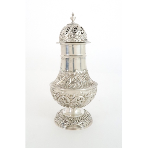 922 - A SILVER SUGAR CASTORby Fenton, Russell Co. Ltd. of baluster shape with embossed foliate decoration ... 