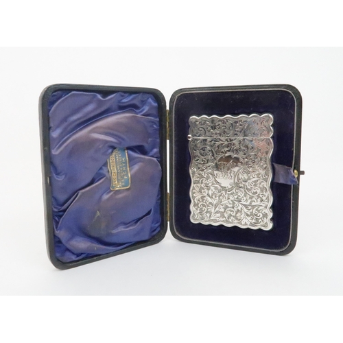 928 - A SILVER CARD CASEby Harry Hayes Birmingham 1903 of rectangular form with shaped edges foliate engra... 