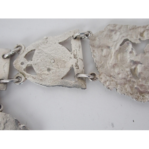 932 - A CONTINENTAL WHITE METAL BELT CHATELAINEunknown marks on the belt buckle the links with figural and... 