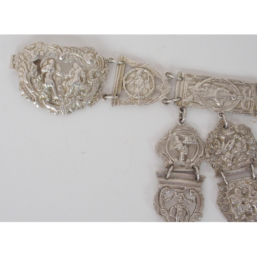 932 - A CONTINENTAL WHITE METAL BELT CHATELAINEunknown marks on the belt buckle the links with figural and... 