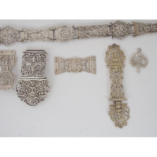 932 - A CONTINENTAL WHITE METAL BELT CHATELAINEunknown marks on the belt buckle the links with figural and... 