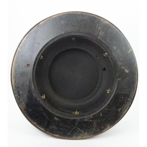 933 - AN EBONISED WOODEN STANDof circular form the concave side applied with seven silver cherubs by Thoma... 