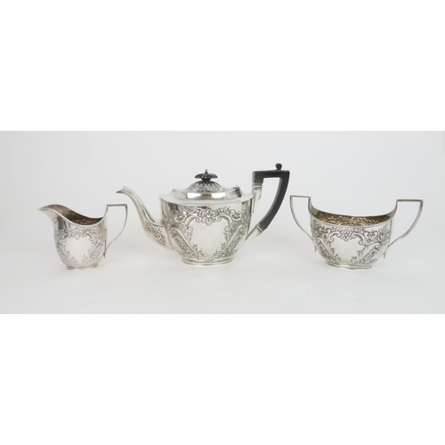 936 - A SILVER THREE-PIECE TEA SETSheffield 1902 by James Deakin & Sons with ebony handle and final, t... 