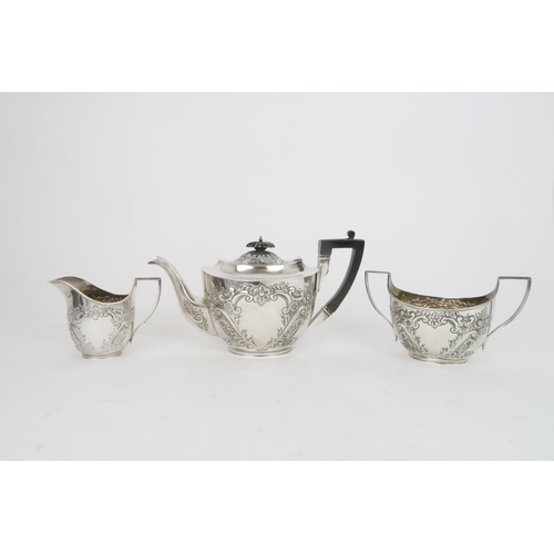 936 - A SILVER THREE-PIECE TEA SETSheffield 1902 by James Deakin & Sons with ebony handle and final, t... 