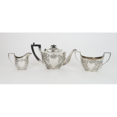 936 - A SILVER THREE-PIECE TEA SETSheffield 1902 by James Deakin & Sons with ebony handle and final, t... 