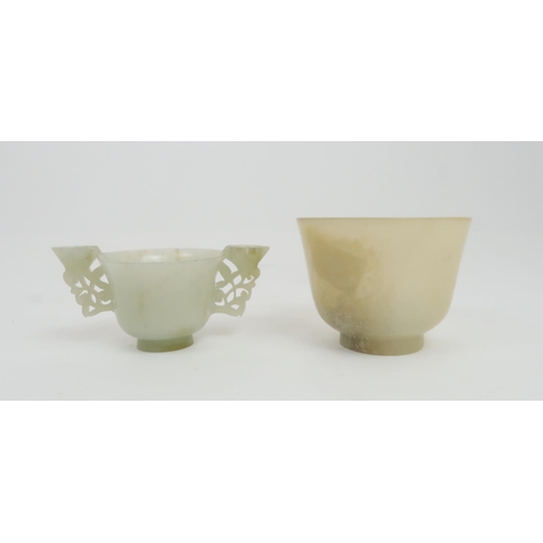 202 - A CHINESE HARDSTONE TWO HANDLED CUP the handles carved with pierced lotus, 4.5cm high and 9.5cm wide... 