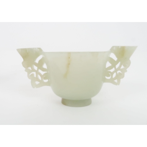 202 - A CHINESE HARDSTONE TWO HANDLED CUP the handles carved with pierced lotus, 4.5cm high and 9.5cm wide... 