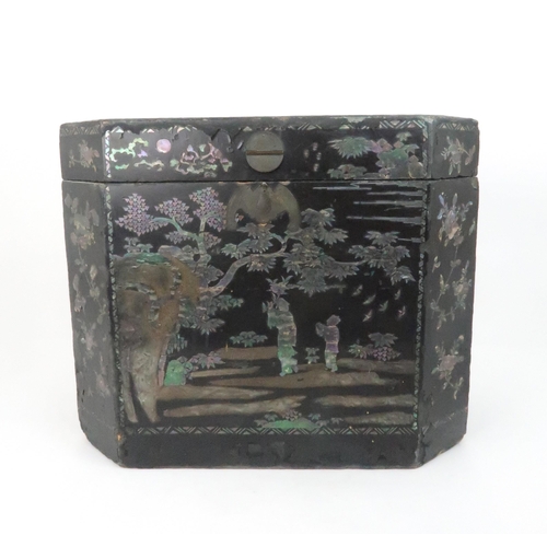 217 - A CHINESE LAC BURGAUTE TEA CHESTthe octagonal box decorated with figures in a garden and surrounded ... 