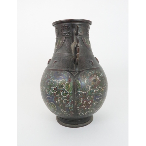 219 - A CHINESE BRONZE AND ENAMEL ARCHAIC STYLE VASEdecorated with foliate panels, beneath applied masks a... 