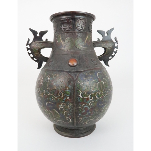 219 - A CHINESE BRONZE AND ENAMEL ARCHAIC STYLE VASEdecorated with foliate panels, beneath applied masks a... 