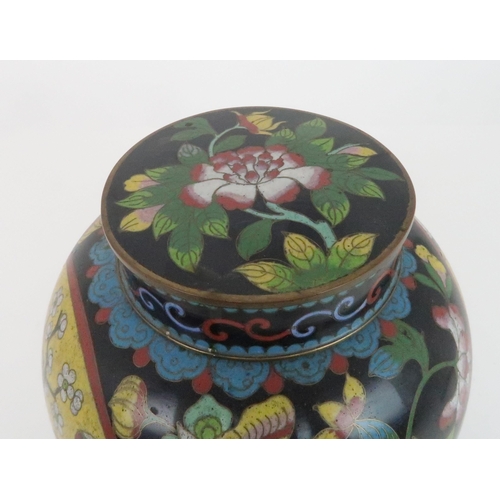 220 - A CHINESE CLOISONNE JAR AND COVERdecorated with panels of precious objects divided by flowers and fo... 