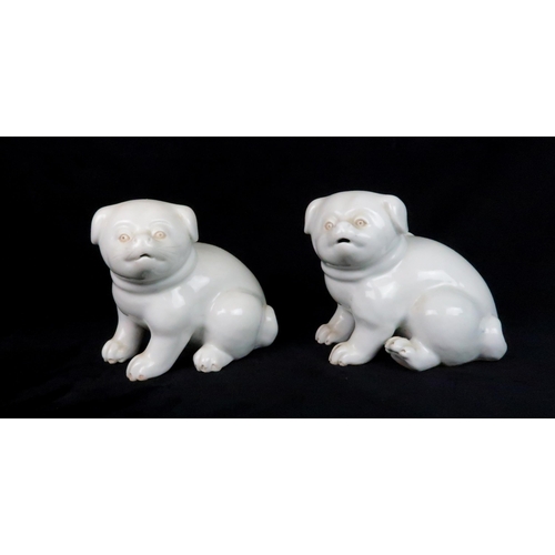 222 - A PAIR OF HIRADO MODELS OF SEATED DOGSeach seated and wearing with ribbon tied collars, 11cm high... 