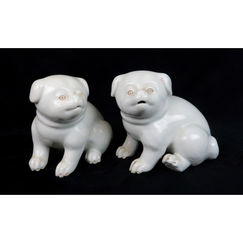 222 - A PAIR OF HIRADO MODELS OF SEATED DOGSeach seated and wearing with ribbon tied collars, 11cm high... 