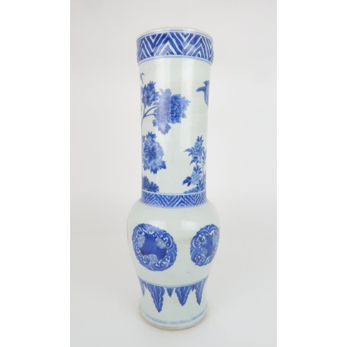 231 - A CHINESE TRANSITIONAL STYLE BLUE AND WHITE VASEpainted with birds amongst bamboo, peonies and chrys... 
