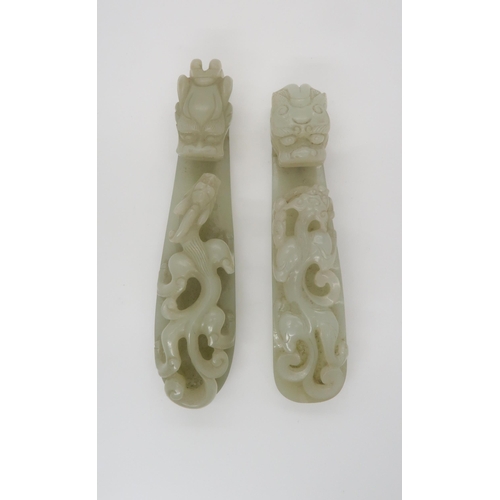 242 - TWO CHINESE JADE BUTTON HOOKSeach carved with a chilong beneath an animal head terminal, 12cm long a... 