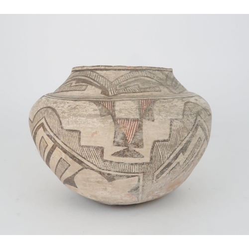 259 - A ZUNI PUEBLO POLYCHROME OLLA (WATER JAR)the inner rim painted black, the top section painted with h... 