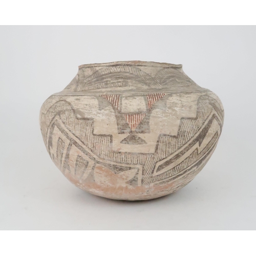 259 - A ZUNI PUEBLO POLYCHROME OLLA (WATER JAR)the inner rim painted black, the top section painted with h... 