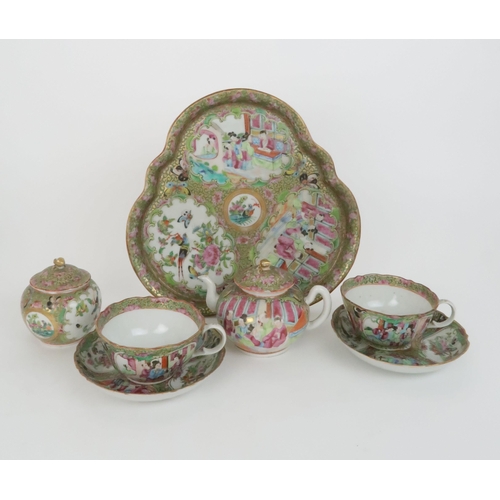 261 - A CANTONESE FAMILLE ROSE TETE A TETEcomprising;tea pot, sugar bowl, tray and two cups and two saucer... 