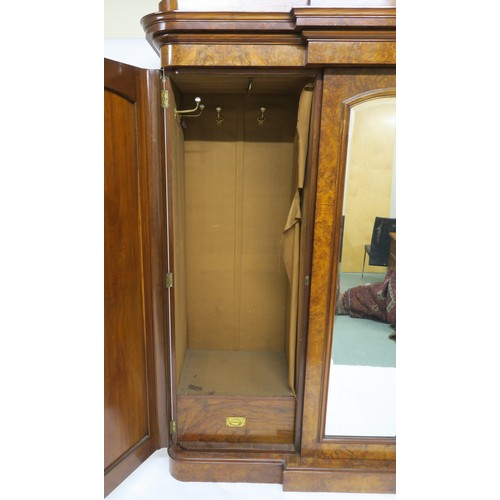 20A - A VICTORIAN BURR WALNUT BREAKFRONT TRIPLE DOOR WARDROBE, with central mirror door flanked by arched ... 