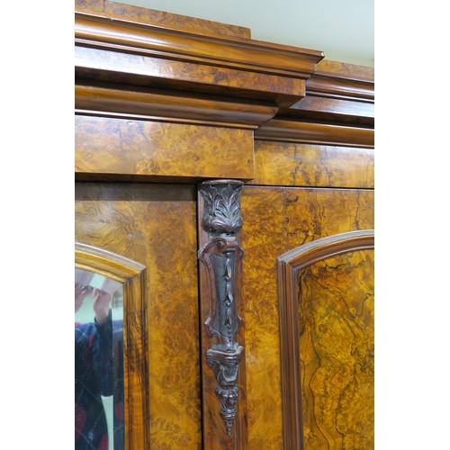 20A - A VICTORIAN BURR WALNUT BREAKFRONT TRIPLE DOOR WARDROBE, with central mirror door flanked by arched ... 