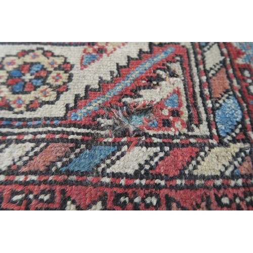 120A - A BLACK GROUND CAUCASIAN RUG, with four medallions and multicoloured borders, 246cm long x 137cm wid... 