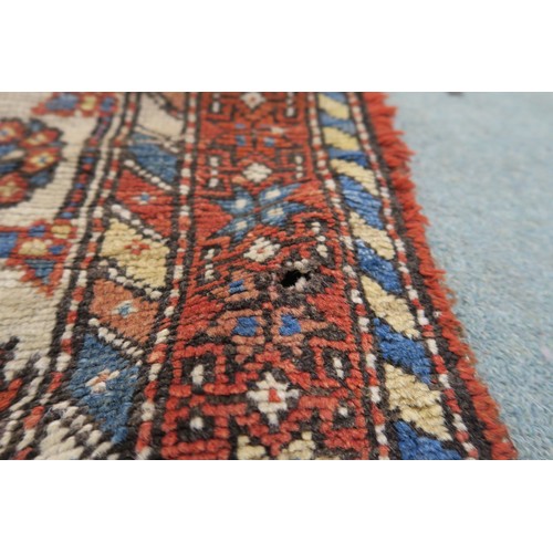 120A - A BLACK GROUND CAUCASIAN RUG, with four medallions and multicoloured borders, 246cm long x 137cm wid... 