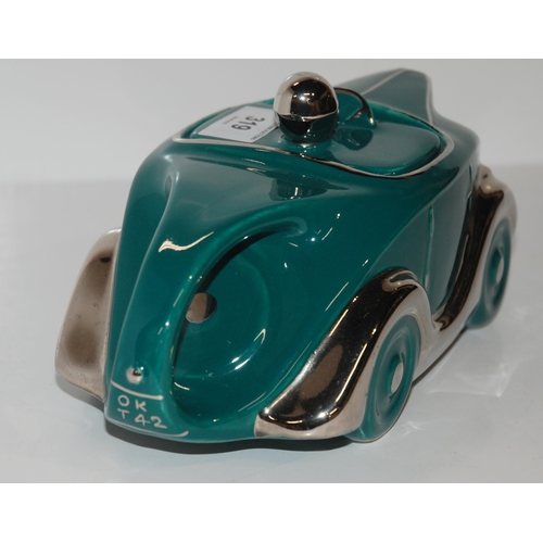 319 - A Sadler OKT42 racing car teapot in teal green glaze...