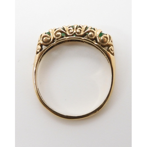 674 - A 9ct gold five emerald ring with classic scrolled mount, size P, weight 2gms...