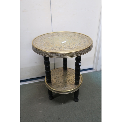 35 - An early 20th century Oriental brass two tiered occasional table on turned supports