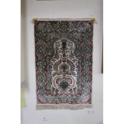 41 - A cream ground tree of life prayer rug with extensive floral and foliate details, 91cm long x 62cm w... 