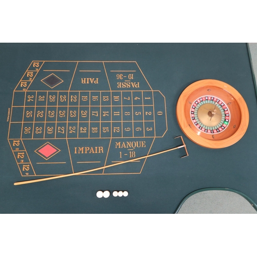 69 - A 20th century French casino roulette table produced by Caro of Paris with shaped baize top, mahogan... 