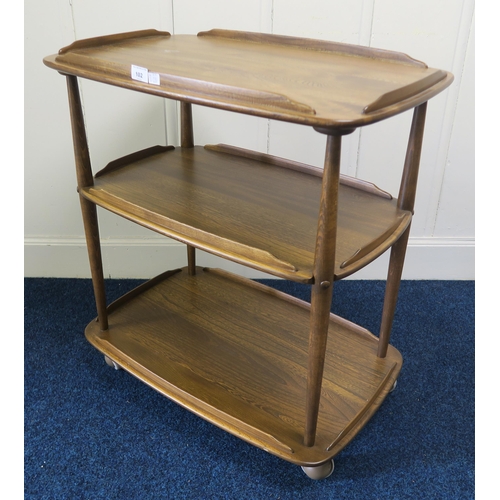 102 - A mid 20th century elm and beech Ercol three tier trolley model 458, 77cm high x 72cm wide x 46cm de... 