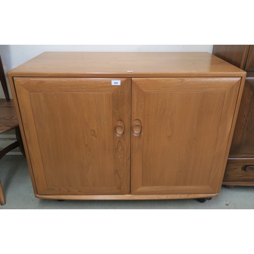 103 - A contemporary elm and beech ercol two door media cabinet, 79cm high x 104cm wide x 57cm deep 